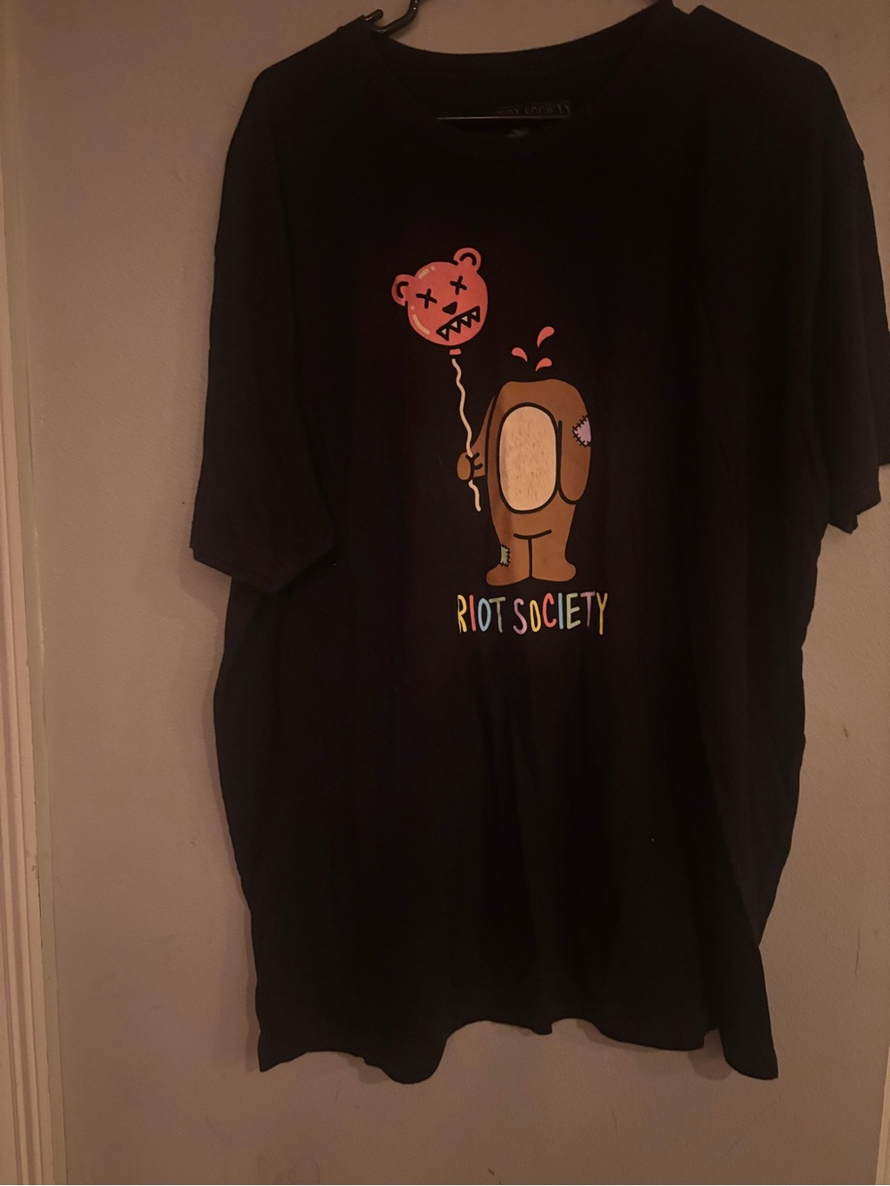 riot society Black Tee with Brown Character and Pink Balloon Graphic